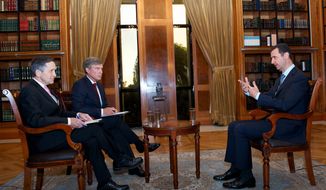 Syrian President Bashar Assad (right) talks with Dennis J. Kucinich (left) and Greg Palkot of the Fox News Channel in Damascus, Syria, on Tuesday, Sept. 17, 2013. (AP Photo/SANA)