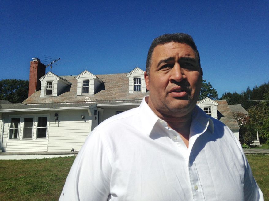 Former NFL offensive lineman Brian Holloway stands in front of his rural vacation home Wednesday, Sept. 18, 2013, in Stephentown, N.Y. Holloway’s rural vacation home was trashed during a Labor Day weekend party attended by an estimated 200 to 400 teenagers. Holloway said the partiers caused at least $20,000 in damage, breaking windows and doors, punching holes in walls and spraying graffiti. (AP Photo/Michael Hill)