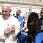 Pope Francis is shown a dog by a member of the Federazione Italiana Sport Cinofili (Italian Federation of Canine Sports) following his weekly general audience at the Vatican on Wednesday, Sept. 18, 2013. (AP Photo/L&#39;Osservatore Romano)