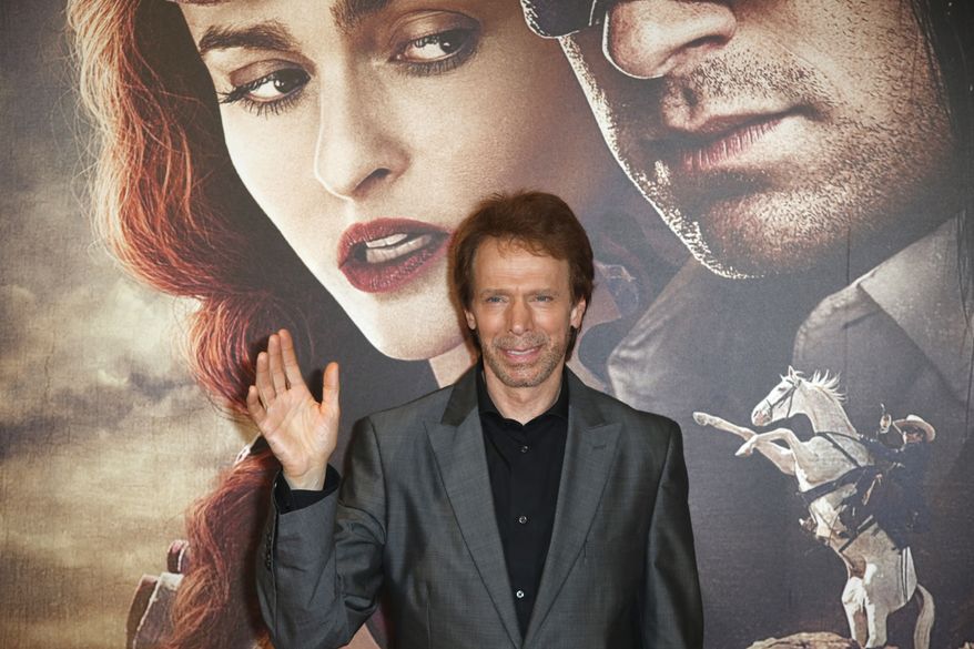 **FILE** Producer Jerry Bruckheimer poses for photographers as he arrives at the cinema for the French premiere of &quot;The Lone Ranger&quot; in Paris on July 24, 2013. (Associated Press)