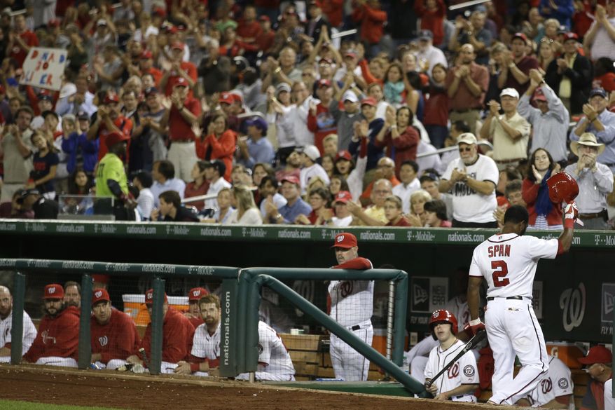 Washington Nationals center fielder Denard Span tips his cap to the fans as they give him an ovation following his fourth at-bat. Span's 29-game hitting streak was snapped on Thursday. (Associated Press photo)