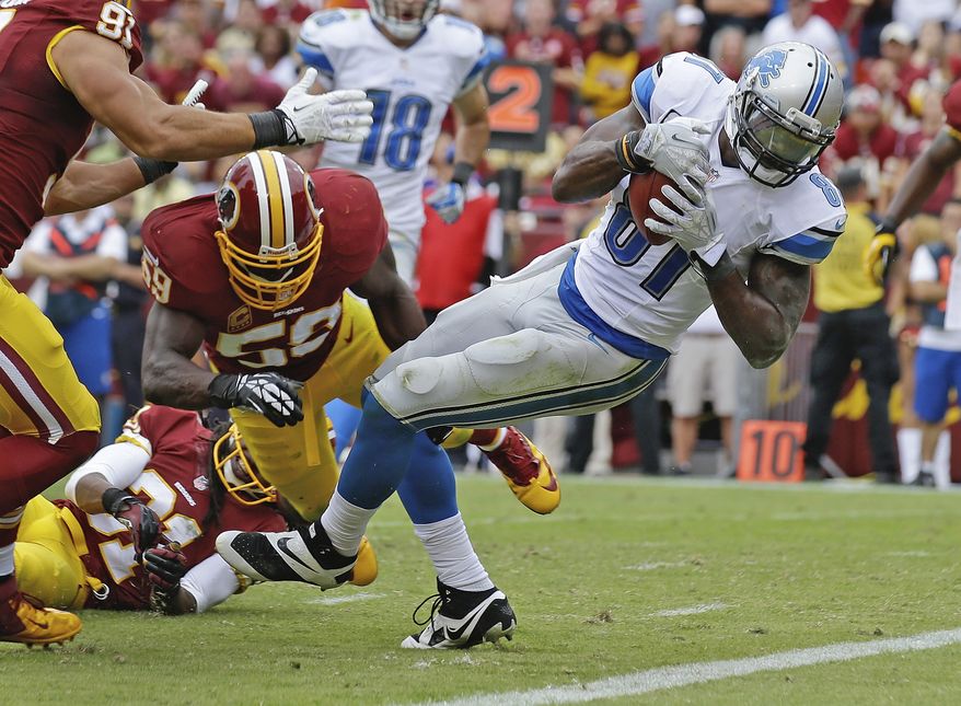Detroit Lions wide receiver Calvin Johnson escapes the grasp of Washington Redskins inside linebacker London Fletcher and rolls into the end zone for a touchdown during the second half of a NFL football game in Landover, Md., Sunday, Sept. 22, 2013. (AP Photo/Alex Brandon)
