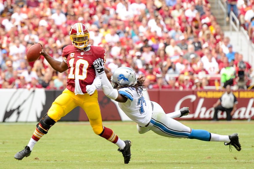 Washington Redskins quarterback Robert Griffin III (10) throws an interception on the run in the second quarter as the Washington Redskins play the Detroit Lions in NFL football at FedExField, Landover, Md., Monday, September 9, 2013. (Andrew Harnik/The Washington Times)