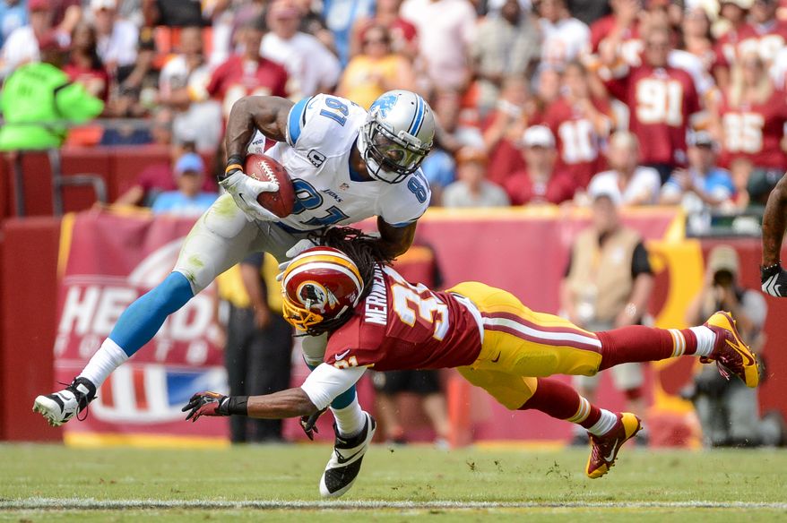 Washington Redskins strong safety Brandon Meriweather (31) tackles Detroit Lions wide receiver Calvin Johnson (81) after he catches a ball for a 20 yard gain as the Washington Redskins play the Detroit Lions in NFL football at FedExField, Landover, Md., Monday, September 9, 2013. (Andrew Harnik/The Washington Times)
