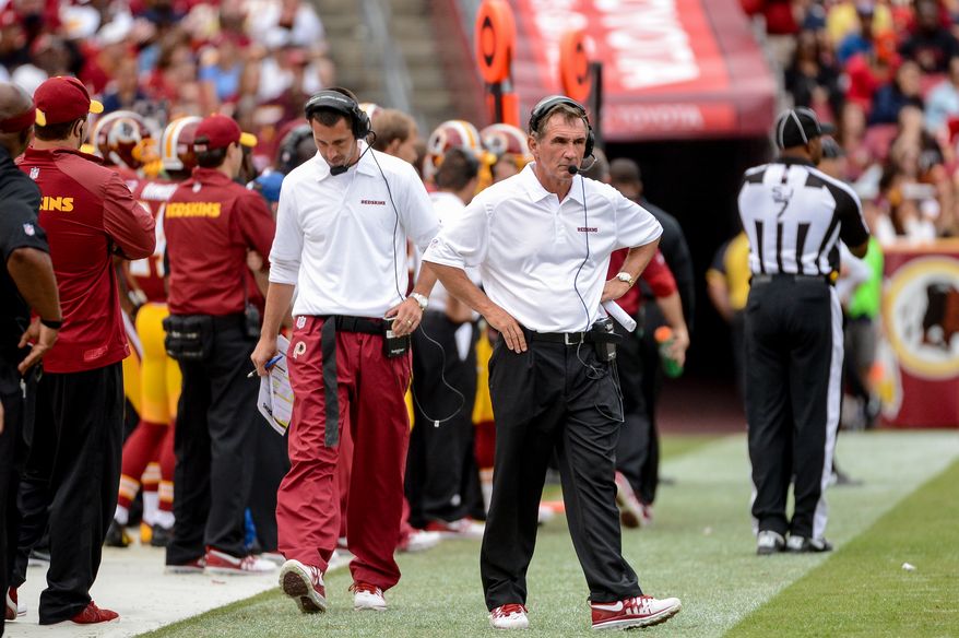 Washington Redskins offensive coordinator Kyle Shanahan, left, and Washington Redskins head coach Mike Shanahan, right, walk the sideline in the third quarter as the Washington Redskins play the Detroit Lions in NFL football at FedExField, Landover, Md., Monday, September 9, 2013. (Andrew Harnik/The Washington Times)