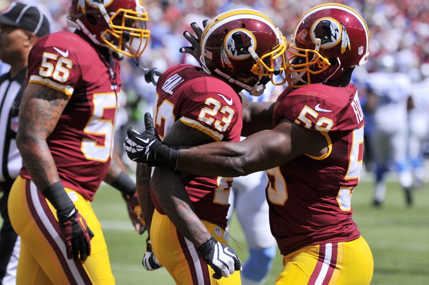 Washington Redskins cornerback DeAngelo Hall (23) is congratulated by inside linebacker London Fletcher (59) after scoring a touchdown on his first quarter interception as the Washington Redskins play the Detroit Lions at FedExField, Landover, Md., September 22, 2013. (Preston Keres/Special for The Washington Times)