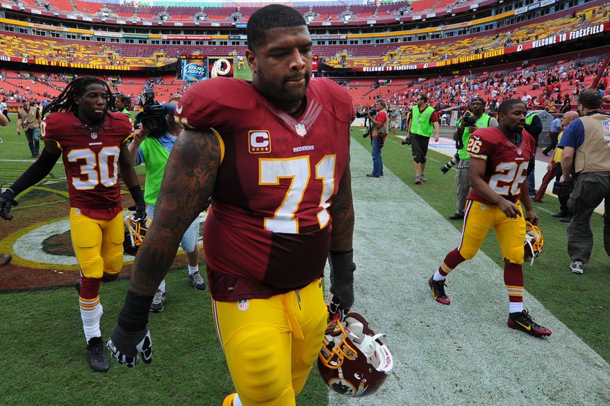 A dejected Washington Redskins tackle Trent Williams (71) walks off the field with teamates after a 27-20 to the Detroit Lions at FedExField, Landover, Md., September 22, 2013. (Preston Keres/Special for The Washington Times)