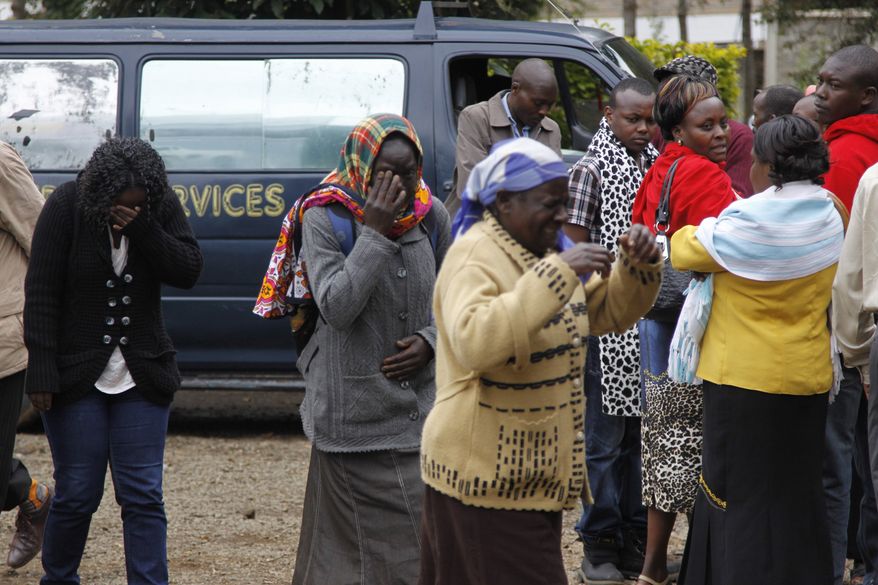 Family members outside the Nairobi City Mortuary in Nairobi mourn the death of loved ones killed in the Westgate attack in Nairobi, Kenya Tuesday, Sept. 24, 2013. (AP Photo/Khalil Senosi)