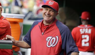 Washington Nationals bench coach Randy Knorr (53) laughs in the dugout before a baseball game against the Philadelphia Phillies at Nationals Park Saturday, Aug. 10, 2013, in Washington. (AP Photo/Alex Brandon)