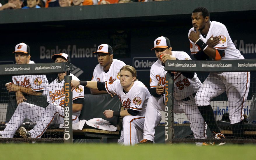 Members of the Baltimore Orioles watch from the dugout in the eighth inning of a baseball game against the Toronto Blue Jays, Tuesday, Sept. 24, 2013, in Baltimore. Toronto won 3-2 in ten innings. (AP Photo/Patrick Semansky)
