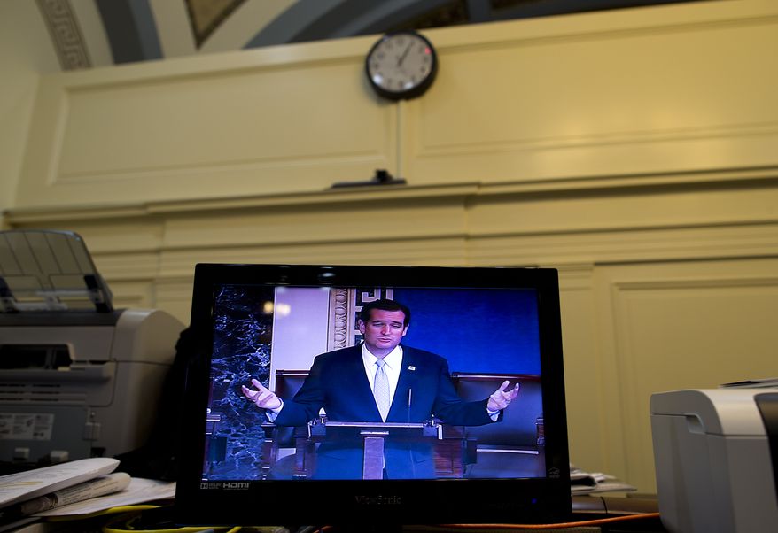 Sen. Ted Cruz, R-Texas, is seen on a television screen in the Senate Press Gallery during the tenth hour of his speech on the Senate floor on Wednesday, Sept. 25, 2013, in Washington. Cruz began a lengthy speech urging his colleagues to oppose moving ahead on a bill he supports. The measure would prevent a government shutdown and defund Obamacare. (AP Photo/ Evan Vucci)