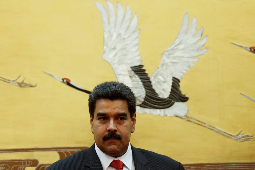 Venezuela's President Nicolas Maduro attends a signing ceremony with Chinese counterpart Xi Jinping, unseen, at the Great Hall of the People in Beijing Sunday, Sept. 22, 2013. (AP Photo/Lintao Zhang, Pool)