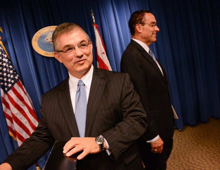 Jeffrey S. DeWitt (left), Phoenix's chief financial officer, was announced by D.C. Mayor Vincent C. Gray as his pick to serve as D.C.'s next chief financial officer, subject to D.C. Council approval. The District is reviewing options if a federal shutdown occurs. (andrew harnik/the washington times)
