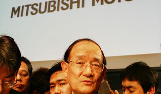 **FILE** Takashi Nishioka, Mitsubishi Motors&#x27; new chairman and CEO, is surrounded by reporters after a news conference a Tokyo hotel on Jan. 28, 2005, to announce the Japanese automaker&#x27;s business revitalization plan. (Associated Press)