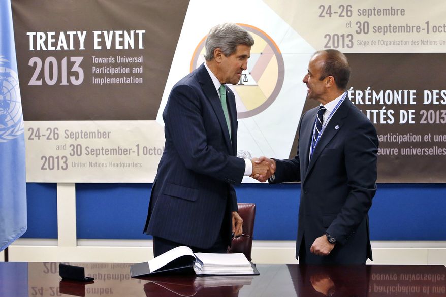 U.S. Secretary of State John Kerry, left, shakes hands with Under Secretary-General for Legal Affairs Miguel Serpa Soares after signing the Arms Trade Treaty during the 68th session of the United Nations General Assembly at U.N. headquarters, Wednesday, Sept. 25, 2013. (AP Photo/Jason DeCrow)