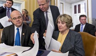 In this Sept. 28, 2013 photo, House Rules Committee Ranking Member Louise Slaughter, D-N.Y., right, and Rep. James P. McGovern, D-Mass., left, examine the wording of the continuing appropriations resolution bill as the panel meets to hear amendments. (AP Photo/J. Scott Applewhite)