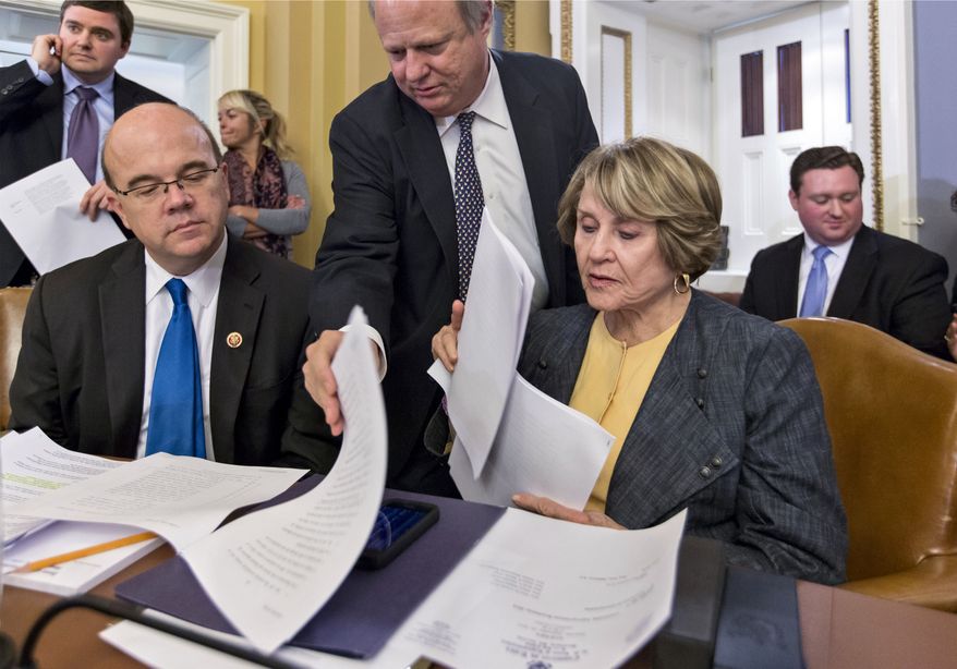 In this Sept. 28, 2013 photo, House Rules Committee Ranking Member Louise Slaughter, D-N.Y., right, and Rep. James P. McGovern, D-Mass., left, examine the wording of the continuing appropriations resolution bill as the panel meets to hear amendments. (AP Photo/J. Scott Applewhite)