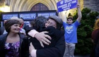 Cindy Meneghin, center right,, hugs her attorney Hayley Gorenberg, center left, during a  rally at Garden State Equality in Montclair, N.J., hours after same-sex marriages were made legal by a state judge, Friday, Sept. 27, 2013. (AP Photo/Julio Cortez)