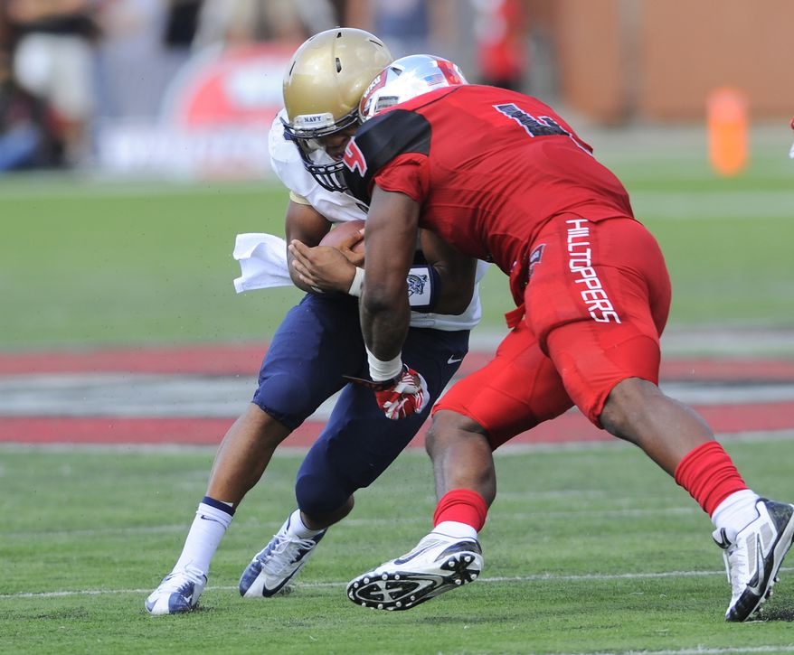 Western Kentucky Hilltoppers linebacker Andrew Jackson (4) hits Navy Midshipmen quarterback Keenan Reynolds (19) during the first half of an NCAA college football game on Saturday, Sept. 28, 2013, in Bowling Green, Ky. Reynolds would leave the game and not return after the hit. (AP Photo/Joe Imel)