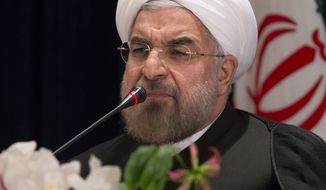 ** FILE ** Iranian President Hassan Rouhani responds to a question during a news conference at the Millennium Hotel in midtown Manhattan, Friday, Sept. 27, 2013, in New York. (AP Photo/John Minchillo)