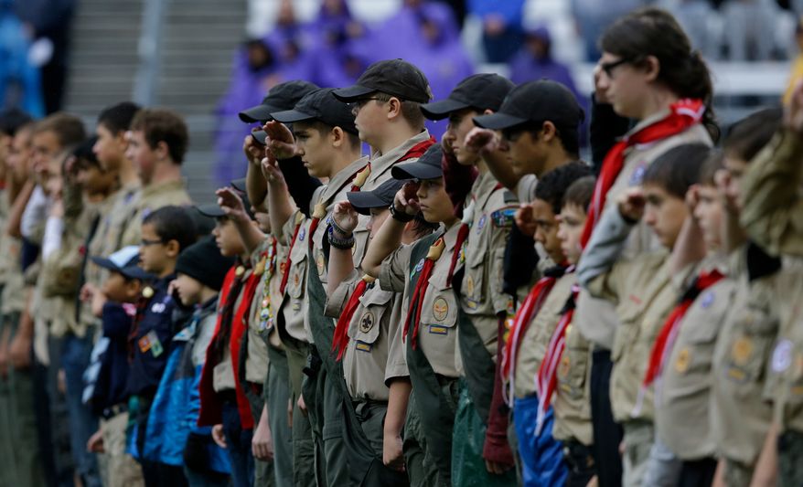 Boy Scouts salute the flag before an NCAA college football game between Arizona and Washington, Saturday, Sept. 28, 2013, in Seattle. (AP Photo/Ted S. Warren)