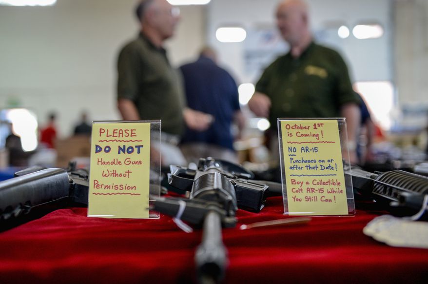A sign warning of the coming assault-weapons ban in Maryland was on display next to AR-15 semi-automatic rifles at a gun show recently in Annapolis. The bill, signed into law by Maryland Gov. Martin O'Malley (below) on May 16, was set to take effect Tuesday pending foes' pursuit of a federal court injunction. (photographs by andrew harnik/the Washington Times)