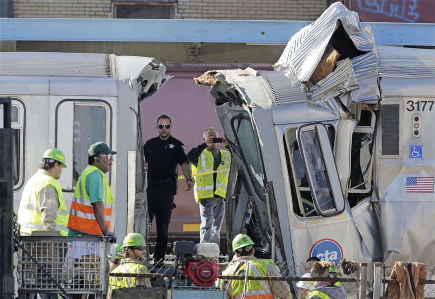 Authorities inspect the wreckage of two Chicago Transit Authority trains that crashed Monday, Sept. 30, 2013, in Forest Park, Ill. The crash happened when a westbound train stopped at the CTA Blue Line Harlem station, and was struck by an eastbound train on the same track. The CTA is investigating the cause of the crash, including why the trains were on the same track. A CTA official said 33 people suffered non-life threatening injuries. (AP Photo/M. Spencer Green)
