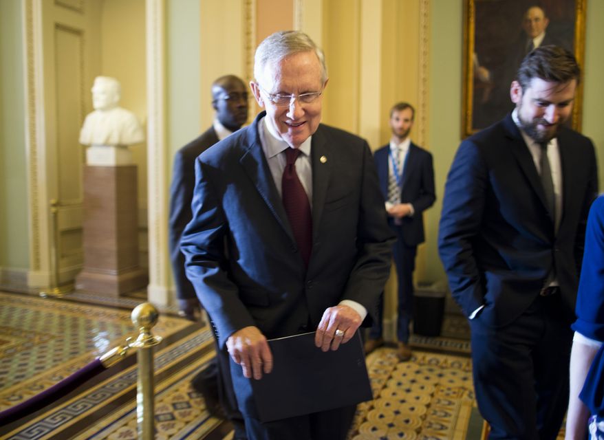 Senate Majority Leader Harry Reid of Nev.,walks to a Senate Democratic caucus to discuss the ongoing budget fight, Monday, Sept. 30, 2013, on Capitol Hill in Washington. Republicans and Democrats blamed each other Monday as they took the federal government to the brink of a shutdown in an intractable budget dispute over President Barack Obama's signature health care law. (AP Photo/ Evan Vucci)