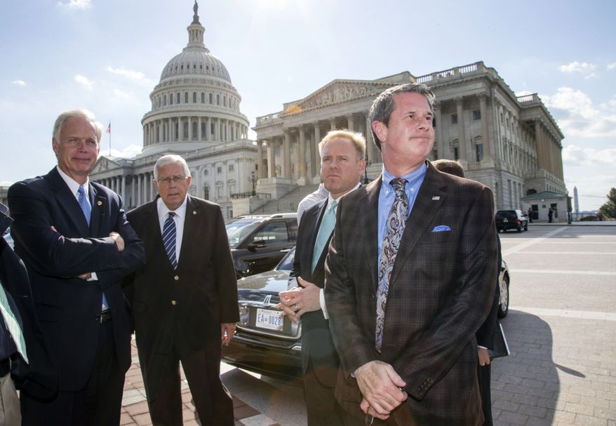 Sen. David Vitter, R-La., far right, assembles a group of conservative voices, including from left, Sen. Ron Johnson, R-Wis., Sen. Mike Enzi, R-Wyo., Brian Baker, president of Ending Spending, to join him in criticizing the Affordable Care Act, at the Capitol in Washington, Monday, Sept. 30, 2013. Vitter told reporters that if Congress is going to write a law that forces Americans to use Obamacare through the individual mandate, then members of Congress should be prepared to do so as well. (AP Photo/J. Scott Applewhite)