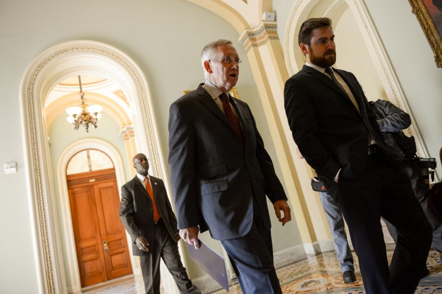Senate Majority Leader Harry Reid (D-Nev.) speaks with his communications director Adam Jentleson, right, as he heads to a meeting with democratic leaders hours before a Monday night deadline on a government funding bill threatens the first government shutdown in 17 years, Washington, D.C., Monday, September 30, 2013. (Andrew Harnik/The Washington Times)