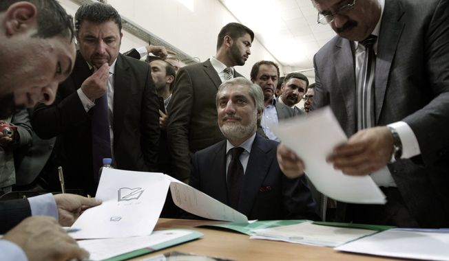 Abdullah Abdullah (center), a prominent Afghan opposition leader, registers his candidacy in next year&#x27;s presidential election in Kabul, Afghanistan, on Tuesday, Oct. 1, 2013.  The election will be key in helping to determine the success or failure of 12 years of U.S.-led military and political intervention in the country. (AP Photo/Rahmat Gul)