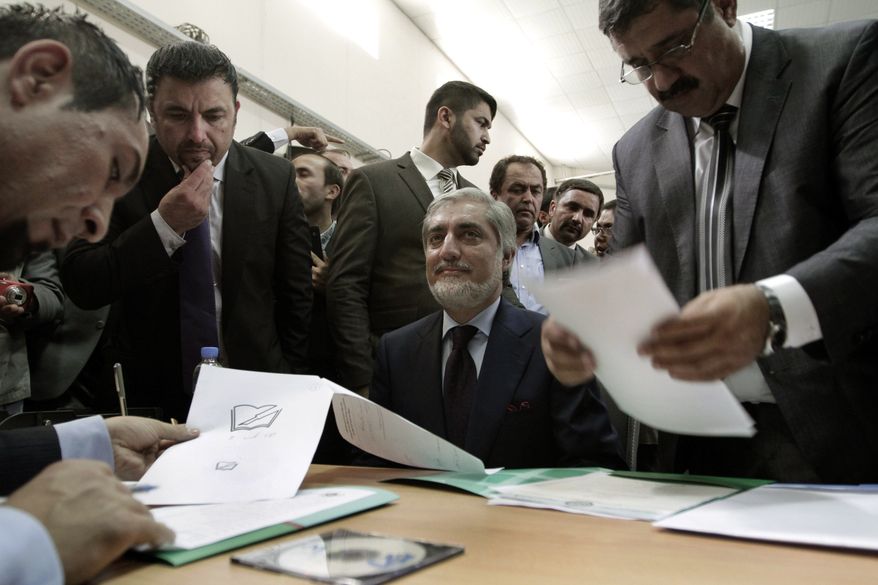Abdullah Abdullah (center), a prominent Afghan opposition leader, registers his candidacy in next year's presidential election in Kabul, Afghanistan, on Tuesday, Oct. 1, 2013. The election will be key in helping to determine the success or failure of 12 years of U.S.-led military and political intervention in the country. (AP Photo/Rahmat Gul)