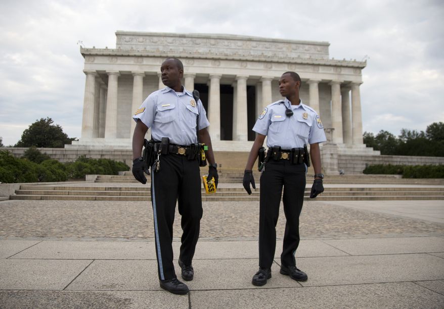 US Park Police officers stand in front of the Lincoln Memorial in Washington, Tuesday, Oct. 1, 2013, as it was closed to visitors. Congress plunged the nation into a partial government shutdown Tuesday as a long-running dispute over President Barack Obama's health care law stalled a temporary funding bill, forcing about 800,000 federal workers off the job and suspending most non-essential federal programs and services. (AP Photo/Carolyn Kaster)