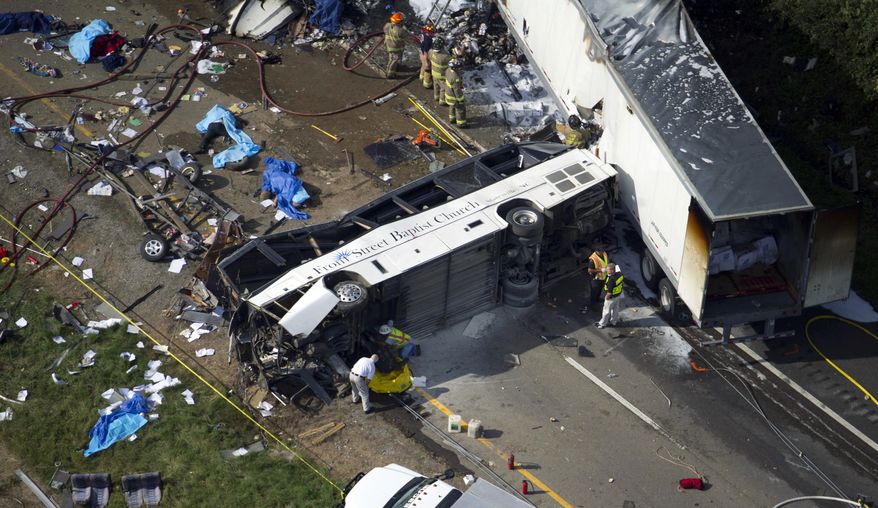 Emergency workers respond to a crash involving a passenger bus, a tractor-trailer and an SUV near Dandridge, Tenn., on Wednesday, Oct. 2, 2013. Authorities said the bus, carrying members of a North Carolina church group, veered across the highway median and crashed into the other vehicles in a fiery wreck that killed several people. (AP Photo/The Knoxville News Sentinel, Paul Efird)