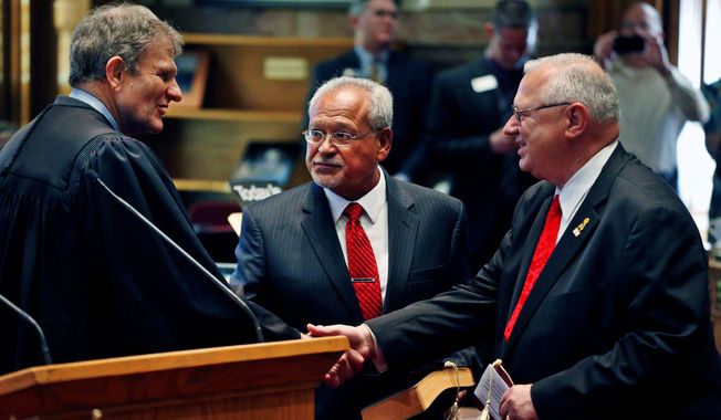 Colorado Supreme Court Chief Justice Michael Bender (left) shakes hands with Bernie Herpin as George Rivera looks on after the two Republicans were sworn in Thursday as state senators, having defeated Democratic senators in a recall over new gun restrictions in October. They replace John Morse and Angela Giron of Pueblo. (ASSOCIATED PRESS)