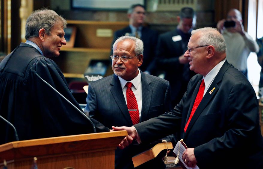 Colorado Supreme Court Chief Justice Michael Bender (left) shakes hands with Bernie Herpin as George Rivera looks on after the two Republicans were sworn in Thursday as state senators, having defeated Democratic senators in a recall over new gun restrictions in October. They replace John Morse and Angela Giron of Pueblo. (ASSOCIATED PRESS)