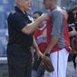 Hall of Famer Cal Ripken Jr., left, meets with Washington Nationals shortstop Ian Desmond, right, during batting practice before a baseball game against the Los Angeles Dodgers, Saturday, July 20, 2013, in Washington. (AP Photo/Nick Wass)