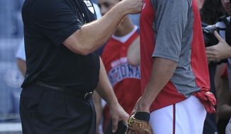 Hall of Famer Cal Ripken Jr., left, meets with Washington Nationals shortstop Ian Desmond, right, during batting practice before a baseball game against the Los Angeles Dodgers, Saturday, July 20, 2013, in Washington. (AP Photo/Nick Wass)