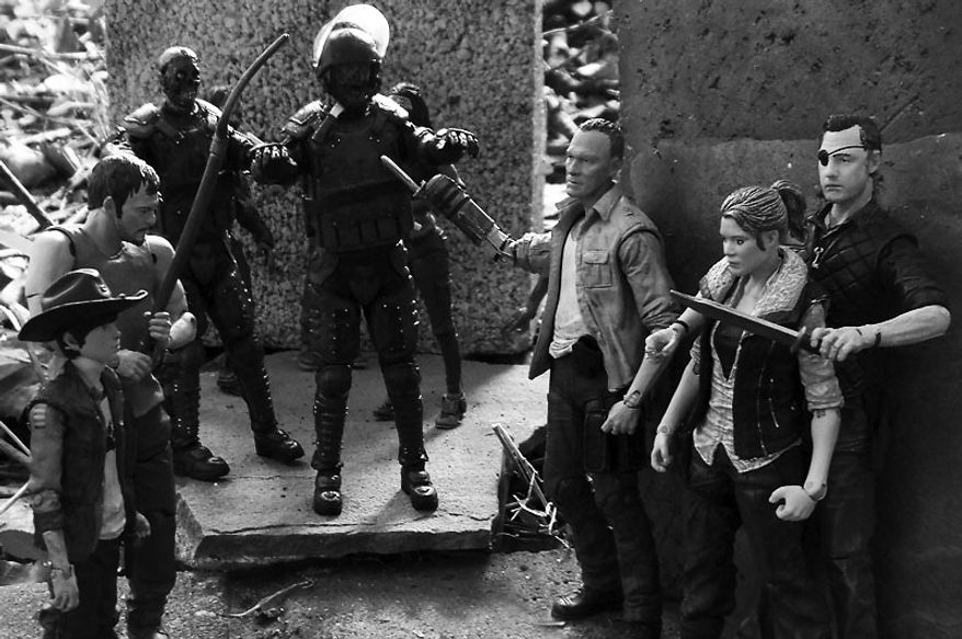 The Governor threatens Andrea as Merle keeps zombies away while Carl and Daryl, look on in McFarlane Toys' The Walking Dead TV Series action figure collection. (Photo by Joseph Szadkowski/The Washington Times)