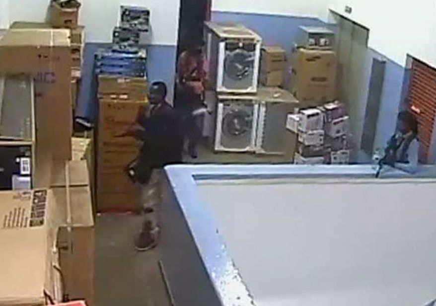 ** FILE ** Men carrying automatic weapons and bags are seen in the storeroom of the Nakumatt shop during the four-day siege at the Westgate Mall in Nairobi, Kenya, which killed more than 60 people in September. A Kenyan military spokesman confirmed the names of four attackers as Abu Baara al-Sudani (left), Omar Nabhan (unseen), Khattab al-Kene (unseen) and Umayr (right). (AP Photo/Kenyan Defense Forces via Citizen TV)