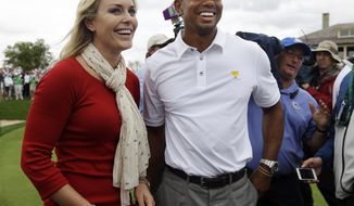 United States team player Tiger Woods, right, smiles with girlfriend Lindsey Vonn after U.S. won the Presidents Cup golf tournament at Muirfield Village Golf Club Sunday, Oct. 6, 2013, in Dublin, Ohio. (AP Photo/Darron Cummings)