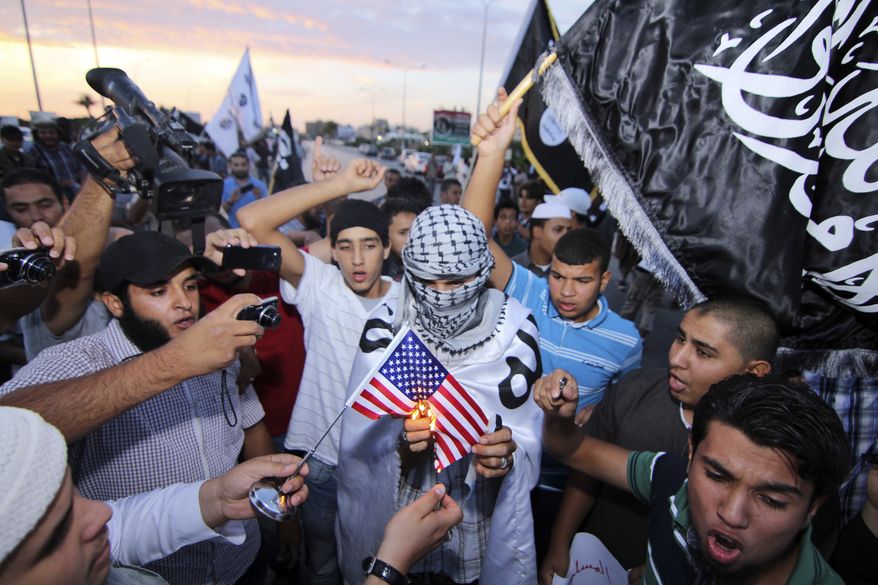 Dozens of supporters of the militant group Ansar al-Shariah burn an American flag and shout anti-American slogans denouncing the U.S. violation of Libya's sovereignty in the abduction of Abu Anas al-Libi, in the center of Benghazi, Libya, on Oct. 7, 2013. Two days earlier, the U.S. Army's Delta Force captured Nazih Abdul-Hamed al-Ruqai, known by his alias Anas al-Libi, an al Qaeda leader linked to the 1998 American Embassy bombings in Kenya and Tanzania. (Associated Press/Mohammed el-Shaiky)