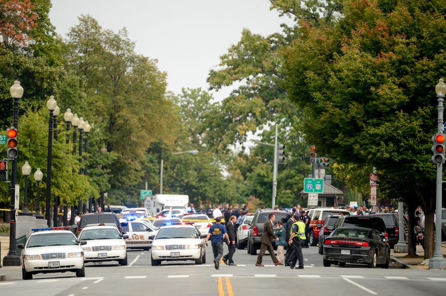 Police vehicles respond after a car chase ended in a shootout at 1st Street and Constitution Ave. NE in front of the Hart Office Building, Washington, D.C., Thursday, October 3, 2013. (Andrew Harnik/The Washington Times)