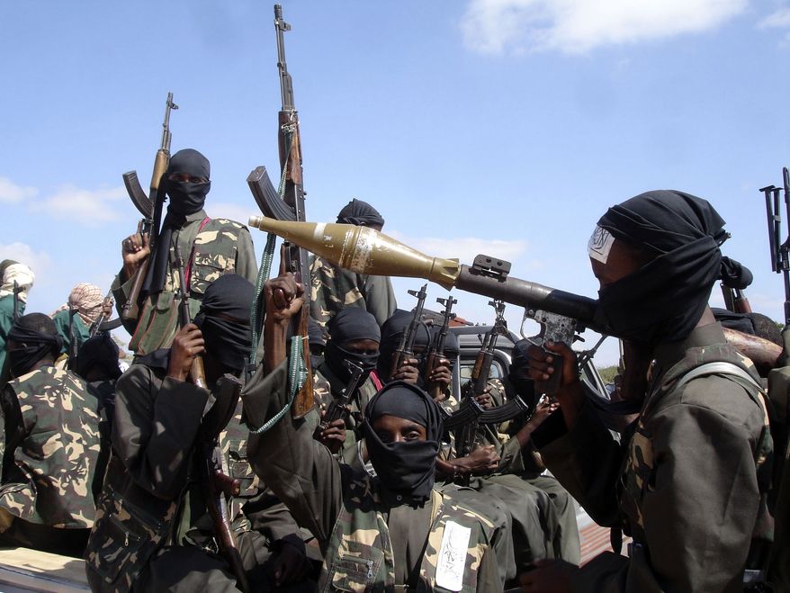 **FILE** Armed al-Shabab fighters just outside Mogadishu prepare to travel into the city in pickup trucks on Dec. 8, 2008, after vowing there would be new waves of attacks against Ethiopian troops. (Associated Press/Farah Abdi Warsameh)