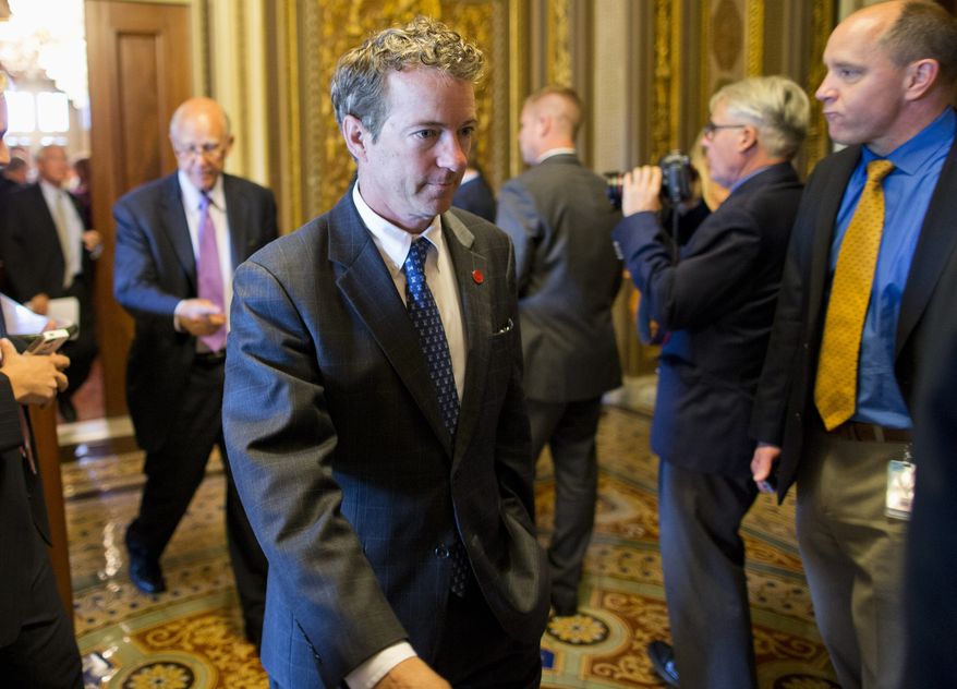 Sen. Rand Paul, R-Ky. walks to the Senate floor on Capitol Hill in Washington, Tuesday, Oct. 8, 2013, after leaving a Republican policy luncheon. House Republicans floated broad hints Tuesday they might be willing to pass short-term legislation re-opening the government and averting a default in exchange for immediate talks with the Obama administration on reducing deficits and changing the three-year-old health care law. (AP Photo/ Evan Vucci)