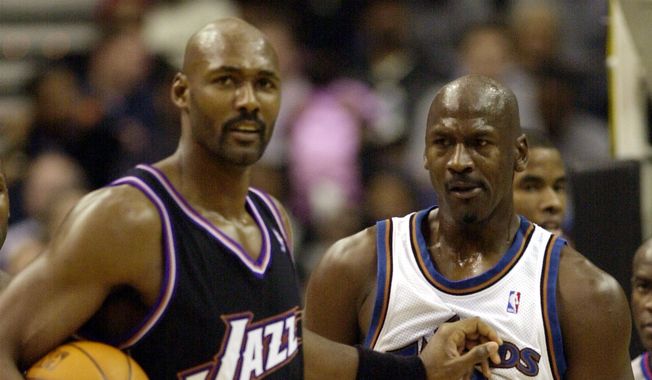 Washington Wizards' Michael Jordan (23) gets a shove by Utah Jazz's Karl Malone, left, during the third quarter of the Wizards' 105-102 win, Thursday, Nov. 14, 2002, at the MCI Center in Washington. (AP Photo/Nick Wass) ** FILE **