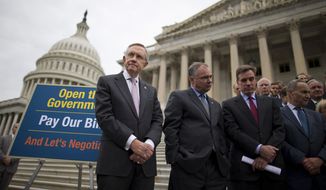 From left, Senate Majority Leader Harry Reid of Nev., Sen. Tim Kaine, D-Va., Sen. Mark Warner, D-Va., Sen. Charles Schumer, D-N.Y., and others stand on the Senate steps on Capitol Hill in Washington, Wednesday, Oct. 9, 2013, during a news conference on the ongoing budget battle. President Barack Obama was making plans to talk with Republican lawmakers at the White House in the coming days as pressure builds on both sides to resolve their deadlock over the federal debt limit and the partial government shutdown.  (AP Photo/ Evan Vucci)