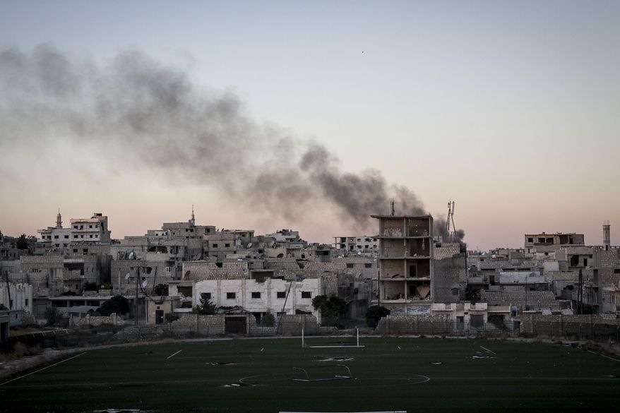 Smoke rises after a mortar shell hits a residential area during fighting between Syrian government forces and rebels in Maaret al-Numan in the Idlib province, Syria, Wednesday, Oct. 9, 2013. Rebels Wednesday overran a military post near the southern city of Daraa, according to the Britain-based Syrian Observatory for Human Rights activist group. Opposition fighters late last month also captured a nearby military base that previously served as the customs office on the outskirts of Daraa. (AP Photo)