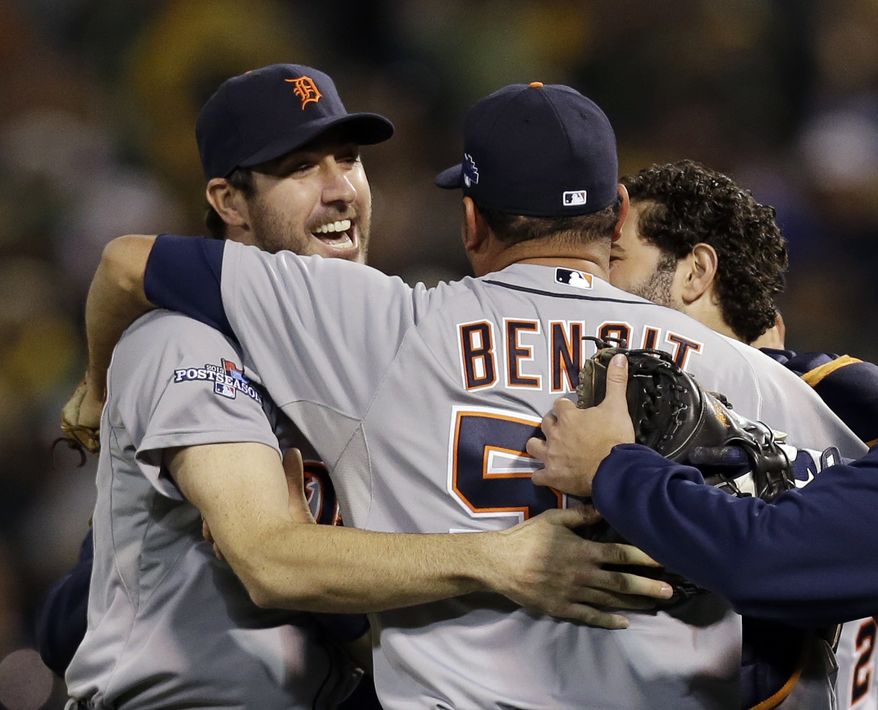 Detroit Tigers pitcher Joaquin Benoit (53) is congratulated by starting pitcher Justin Verlander, left, after the Tigers beat the Oakland Athletics 3-0 to win Game 5 of an American League baseball division series in Oakland, Calif., Thursday, Oct. 10, 2013. (AP Photo/Marcio Jose Sanchez)