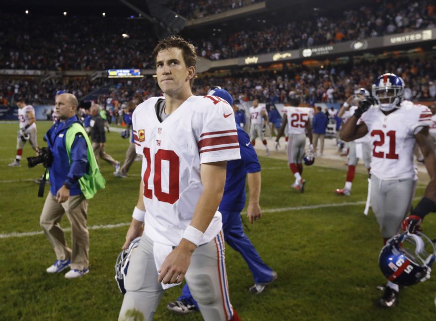 New York Giants quarterback Eli Manning (10) walks off the field after the Giants' 27-21 loss to the Chicago Bears in an NFL football game, Thursday, Oct. 10, 2013, in Chicago. (AP Photo/Charles Rex Arbogast)